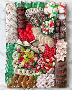 an assortment of christmas cookies and pastries on a board