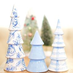 three blue and white ceramic christmas trees on a table