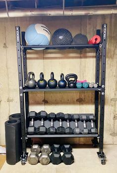 a rack filled with dumbs, kettles and balls