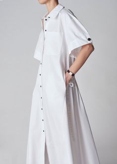 Short sleeve shirt dress in crisp cotton poplin. Striking A-line silhouette. Cuffed sleeve hem with tab. Exposed button closure. Optional drawstring cinch to style this dress in a variety of ways. Midi length. 4873STN-CORE 100% Cotton White True to size. Approx 53" center front body length. Model is 5'10" wears a size Small. Short Sleeve Shirt Dress, Wrap Shirt Dress, Instagram Editor, Shirt Dress Pattern, Cuffed Sleeve, Short Sleeve Dress Shirt, Denim Shoes, Cotton Viscose, Shirtdress