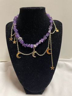 Estela is our amethyst, gold, and moon charm necklace.  ~It is made with a variety of star and moon charms. The necklace is made of gold chains and is brought together by a lobster clasp.  ~This necklace has extra chain so size adjustments can be made if needed.  ~Please choose either the sun or moon as the middle charm.  ~All of our necklaces are handmade Product Care:  -Apply beauty products such as perfume, hairspray or deodorant before wearing your jewelry as certain chemicals in these products may damage the finish. -Always remove your jewelry before swimming, bathing, doing household chores or using abrasive cleaners  If you have any questions let us know and we will be happy to answer them. Have a nice day! Mystical Purple Necklace For Festivals, Handmade Celestial Amethyst Necklace, Celestial Amethyst Purple Necklace, Celestial Purple Amethyst Necklace, Adjustable Celestial Crystal Necklaces With Moon Charm, Adjustable Purple Moon Phase Jewelry, Adjustable Celestial Crystal Necklace With Moon Charm, Celestial Amethyst Moon Charm Jewelry, Celestial Amethyst Jewelry With Moon Charm