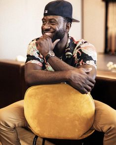 a man sitting on top of a yellow chair