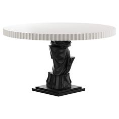 a black and white table with a statue on it's base, in front of a white background