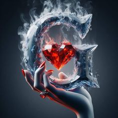 a woman's hand holding a heart surrounded by fire and ice