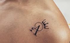 a man with a tattoo on his chest has the letter e in it's upper half