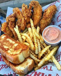 fried chicken sandwich with fries and dipping sauce