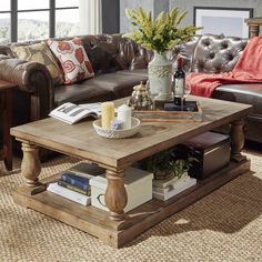 a living room with leather couches and a coffee table in front of a window