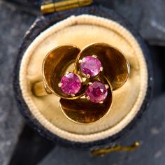 two gold rings with pink stones in them