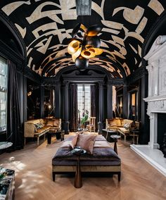 a living room filled with furniture and black walls