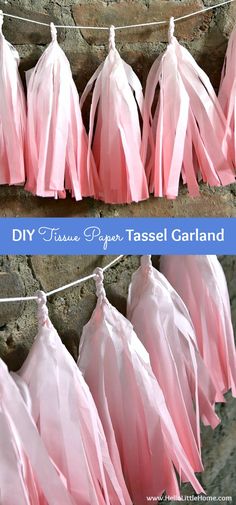 pink tissue paper tassel garlands hanging from clothes line with text overlay that says diy tissue paper tassel garland