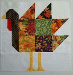 a close up of a bird made out of patchwork