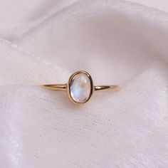 "Materials Gold, Rose gold, White gold Moonstone Ring / Oval Cut Moonstone Ring In 14k Gold / Stackable Moonstone Ring / Natural Moonstone / June Birthstone Ring / Gemstone Ring Item Features * Made to Order. * Gold KT: 14K solid gold * Custom Gold Color: Rose Gold, Yellow Gold, White Gold * Gemstone Cut: Oval * Number of Stones: 1 * Stone Size: 6x4 mm * Setting Type: Bezel * Band Width: 1.25mm * Ring is marked gold Marked * ready to Ship in 7-10 Business Days * Also available in other gemstone Dainty Oval Cabochon Gemstone Rings, Gift Moonstone Ring In 14k Gold With Oval Cabochon, 14k Gold Moonstone Ring Gift, Oval Cabochon, Gift 14k Gold Moonstone Ring Oval Cabochon, 14k Gold Moonstone Ring Oval Cabochon For Gift, 14k Gold Cabochon Moonstone Promise Ring, Yellow Gold Oval Moonstone Ring For Gift, Celestial Style Oval Cabochon Gemstone Ring, Celestial Oval Cabochon Gemstone Rings