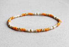 Orange, Beige, Cream & Gold Bracelet - 3mm beads - stretchy I can make the bracelet to your size.  Just send me a message or you will receive a standard size bracelet. Tiny Bead Bracelet, Funky Bracelet, Stretchy Beaded Bracelet, Bracelet Keychains, Friendship Bracelets With Beads, Orange Bracelet, Friendship Bracelets Designs, Beaded Jewelry Necklaces, Hippie Bracelets