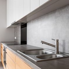 a kitchen with stainless steel counter tops and wooden cabinets