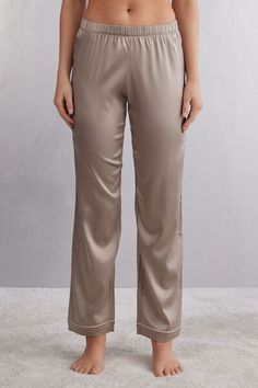 Full length pants in light stretch silk satin with contrast trim, available in different colors, at the hem. Elegant and comfortable, they are perfect for a nighttime outfit or refined loungewear. Elegant Satin Sleepwear With Long Pants, Elegant Silk Bottoms For Loungewear, Elegant Satin Pants For Loungewear, Elegant Wide Leg Bottoms For Pajama Party, Elegant Silk Loungewear Bottoms, Satin Trousers For Loungewear, Elegant Satin Long Pants Sleepwear, Silk V-neck Sleepwear For Wedding Night, Fitted Satin Finish V-neck Sleepwear