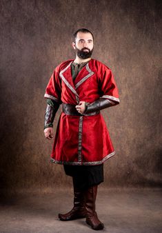 a man with a beard wearing a red outfit