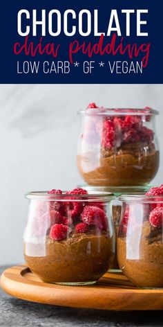 three jars filled with chocolate and raspberries sitting on top of a wooden tray