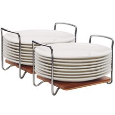 four white plates stacked on top of each other with black metal frames and wood bases