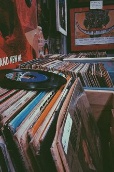 a record player sitting on top of a pile of records