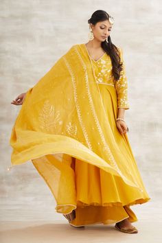 Mustard yellow anarkali with foil printed floral motifs on yoke. Comes with gharara and dupatta.
Component: 3
Embroidery
Neckine: V neck
Sleeve Length: Three fourth
Fabric: Chanderi
Color: Yellow
Printed floral motifs on dupatta with tassel detail on hem
Embroidered detail on neckline, waistline and sleeve hems - Aza Fashions Yellow Anarkali, Silk Nightgown, Saree Blouse Patterns, Designer Saree Blouse Patterns, Patterned Dress, Yellow Print, Designer Saree, Indian Designer Wear, Designer Gowns