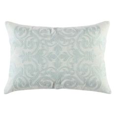 a light blue and white pillow with an intricate design on the front, sitting against a white background