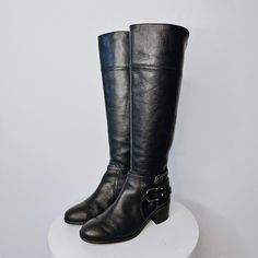 "Designer knee high leather riding boots with buckle detailing and stretch back to allow a comfortable fit. Made by Marc Fisher Leather Upper and Man Made Sole Size: 7M Insole Length: 9.75\" Insole Width: 3.5\" Heel Hight: 2\" Condition: Exterior and interior is in excellent preloved condition.  All preloved shoes have been cleaned and sanitized. Please note: All sales are final and sold \"as is\".  You are purchasing a preloved item.  You will receive the exact piece that is pictured.  I will a Marc Fisher Boots Black, Stretch Back, Black Knees, Leather Riding Boots, Marc Fisher, Boot Shoes Women, Riding Boots, Knee High, Womens Boots