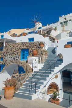 the stairs are made of stone and have blue windows