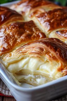 a casserole dish filled with cheese and meat