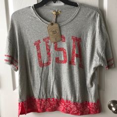 a t - shirt with the word usa on it hanging from a door hanger