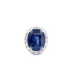 an oval shaped blue sapphire and diamond ring with white diamonds around the center, set in 18k white gold