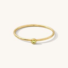 Our August Birthstone Ring is a dainty gold filled stacking ring featuring a peridot-colored cubic zirconia. A simple but stylish little piece you can wear every day, this ring will make everyday feel like your birthday! Wear it alone for a dainty look, or stack it with your other favorite rings. DETAILS 14k gold filled ring 1mm band with 2mm light peridot-colored cubic zirconia Available in sizes 5-10 Safe for sensitive skin & shower safe Matching jewelry: August Birthstone Stud Earrings, Birth Gold Stackable Rings With Peridot Birthstone, Everyday Green Stackable Rings, Gold May Birthstone Everyday Ring, Green Minimalist Birthstone Ring With Round Band, Everyday Green Stackable Rings With Bezel Setting, Green Stackable Rings For Everyday, Everyday Green 14k Gold Stackable Rings, Minimalist Green Birthstone Ring, Dainty Stackable Rings For May Birthstone