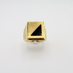 Inventory #:  GROx-001270A Stunning Heavy Vintage New 18K Yellow Gold Rectangular Black Onyx Ring/ Triangle Onyx Shape/ Signet Ring Area/ Art Deco Style/ Size 11 ½ / 13.66 Grams This is a truly unique ring that can be engraved with initials opposite the onyx. This is a New- Never worn ring from a 1989 jewelry store close out. The 2nd picture is taken on macro for more detail Size: 11 1/2 Metal:  18K Yellow Gold Weight: 13.663 grams.  There are 31.1 grams to an ounce, for reference.   Dimensions:  The ring is 11/16" wide x 5/8" across x 5.46mm thick and tapers in back to 4.26mm wide.   The dime is 1.3mm thick, for reference. Stones:  Black onyx.  Triangle area is 12.95mm x 9.41mm x 9.13mm.  The onyx is 3.8mm thick.   Maker:  Levian Arrives Gift Boxed We have a generous 30 day return policy Modernist Rectangular Signet Ring For Anniversary, Rectangular Onyx Gemstone Rings, Rectangular Onyx Ring For Formal Occasions, Gold Rectangular Modernist Signet Ring, Modernist Gold Rectangular Signet Ring, Black Rectangular Signet Ring For Anniversary, Hallmarked Black Rectangular Rings, Gold Art Deco Enamel Ring For Formal Occasions, Formal Rectangular Onyx Ring