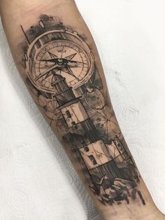 a man's arm with a clock and compass tattoo on the left inner forearm