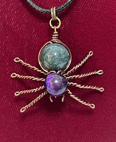 This beautiful handmade wire wrapped Spider Pendant is a wonderful gift for those who have a soft spot for spiders or simply adore unique and playful jewelry. This charming pendant is crafted with love and attention to detail, making it a perfect addition to any collection of one-of-a-kind jewelry pieces. This Spider Pendant measures approximately 1 inch by 1.4 inches. It is made of copper wire with a Moss Agate bead body and a Purple Tiger Eye bead head.  It will arrive attached to a simple black 16" cord necklace. Your Spider Pendant will arrive packaged in an organza bag (colors will vary), which is suitable for gift giving. I will add a message of your choice to the package for you, if you would like to have it mailed directly as a gift.  You can click on "personalization" and add your Purple Tiger, Spider Pendant, Playful Jewelry, Spider Jewelry, Eye Gift, Soft Spot, Handmade Wire Wrapped, Tiger Eye Beads, Welding Art