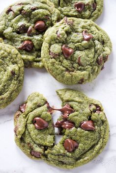 green chocolate chip cookies on a white surface