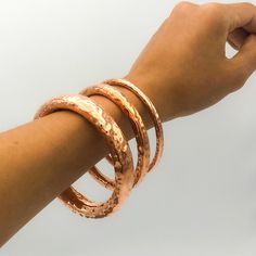 "DON 925's master silversmiths handcrafted with genuine copper these chunky bangles with hammered details. Perfect to stack them or beautiful on their own too! These bangles are hollow, sturdy and rigid. Thickness: 5 mm Inner Diameter: 6.2 cm (2.40\") Inner Circumference: 19.8 cm (7.80\") Weight: 17.4 grams Thickness: 8 mm Inner Diameter: 6.2 cm (2.40\") Inner Circumference: 19.8 cm (7.80\") Weight: 33.5 grams Thickness: 14 mm Inner Diameter: 6.5 cm (2.55\") Inner Circumference: 20.2 cm (7.95\") Unique Hammered Copper Bracelets, Hammered Copper Bangle Bracelets, Hammered Copper Bangle Bracelet, Artisan Electroformed Bangle Bracelets, Artisan Hammered Bangle Bracelet, Chunky Bangles, Big Statement Rings, Jewelry Real, The Bangles