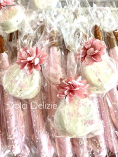 pink and white cupcakes wrapped in cellophane with flowers on each one