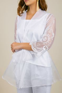 PRODUCT DETAIL: This White Organza set is perfect for any semi-formal and formal occasion. The cape has beautiful thread embroidery on the sleeves. It has an organza belt to highlight the overall look. The undershirt and the bottoms are in white cotton fabric. It is a very smart and trendy outfit. A must-have! *The length of the top and bottom can be altered according to client preference. Reach out to get yours customized! SPECIFICATIONS: Color White Fabric Organza and Cotton Blend Product Code Organza Cape, Cape Set, Embroidered Cape, Trendy Outfit, Thread Embroidery, White Fabric, White Fabrics, Western Wear, Bridal Wear