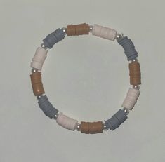 The Western Pink Bracelet has brown, gray, and very light pink beads with pearls in between. Western Heishi Bracelet, Western Clay Bead Bracelet, Happy Halloween Sign, Happy Halloween Signs, Jewelry Clay