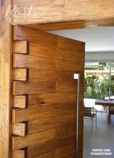 an open wooden door leading into a dining room