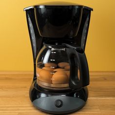 an electric coffee maker with eggs in it