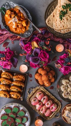 a table filled with lots of different types of food and desserts on top of it