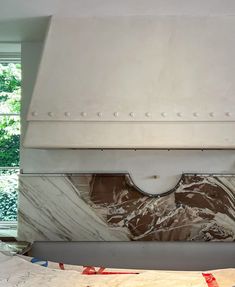 a large white stove top oven sitting inside of a kitchen next to a wall mounted oven