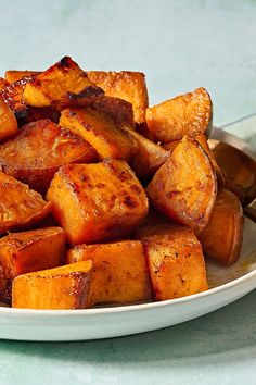 a white plate topped with cooked sweet potatoes