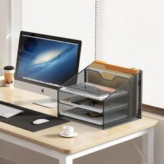 a desktop computer sitting on top of a desk next to a keyboard and mouse pad