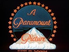 a sign that says a paramount picture with stars around it and a mountain in the background