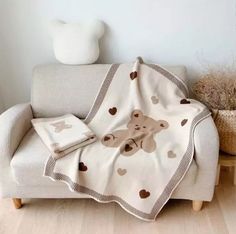 a teddy bear blanket sitting on top of a couch