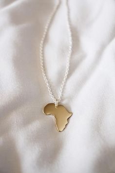 This little necklace needs no explanation – I love my continent!If you live in Africa or have travelled to Africa, then this luxurious gold Lola&Cash creation is for you - Handmade with love in Africa!If you have another State, Country or Continent in mind, maybe an Island, I can make most shapes, and the price will be the same - so let me know where your heart lies.— d e t a i l s —-plain Africa pendant measures 2cm tall-hand sawn from solid 9ct yellow gold-includes a complimentary 45cm sil Yellow Gold Pendant Necklace As Souvenir, Yellow Gold Pendant Jewelry Souvenir, Gold Pendant Necklace As Souvenir, Yellow Gold Pendant Jewelry For Souvenir, Yellow Gold Pendant Jewelry As Souvenir, Gold Necklace With Large Pendant In Recycled Gold, Gold Engraved Jewelry Souvenir, Engraved Gold Jewelry As Souvenir, Engraved Pendant Necklace Souvenir