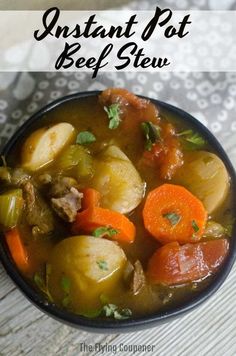 a bowl of beef stew with carrots, potatoes and parsley on the side