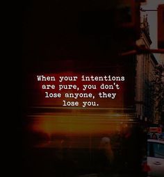 a city street filled with traffic next to tall buildings and a sign that says, when your intentionss are pure, you don't lose anyone, they lose you